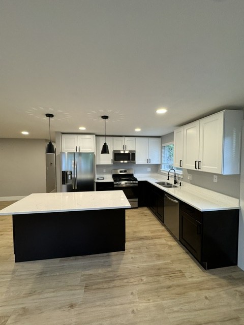 Updated kitchen with white and dark cabinetry