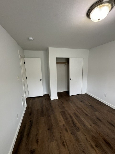 Bedroom interior with new flooring and closet