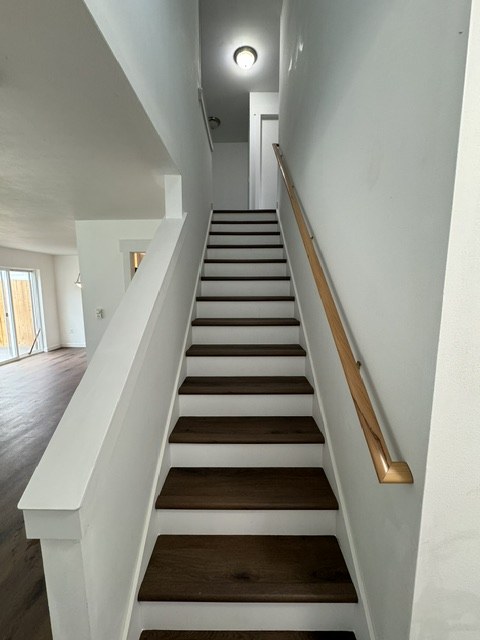 Staircase with dark wood treads and wood handrail